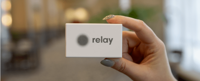 A hand holding a relay bluetooth beacons