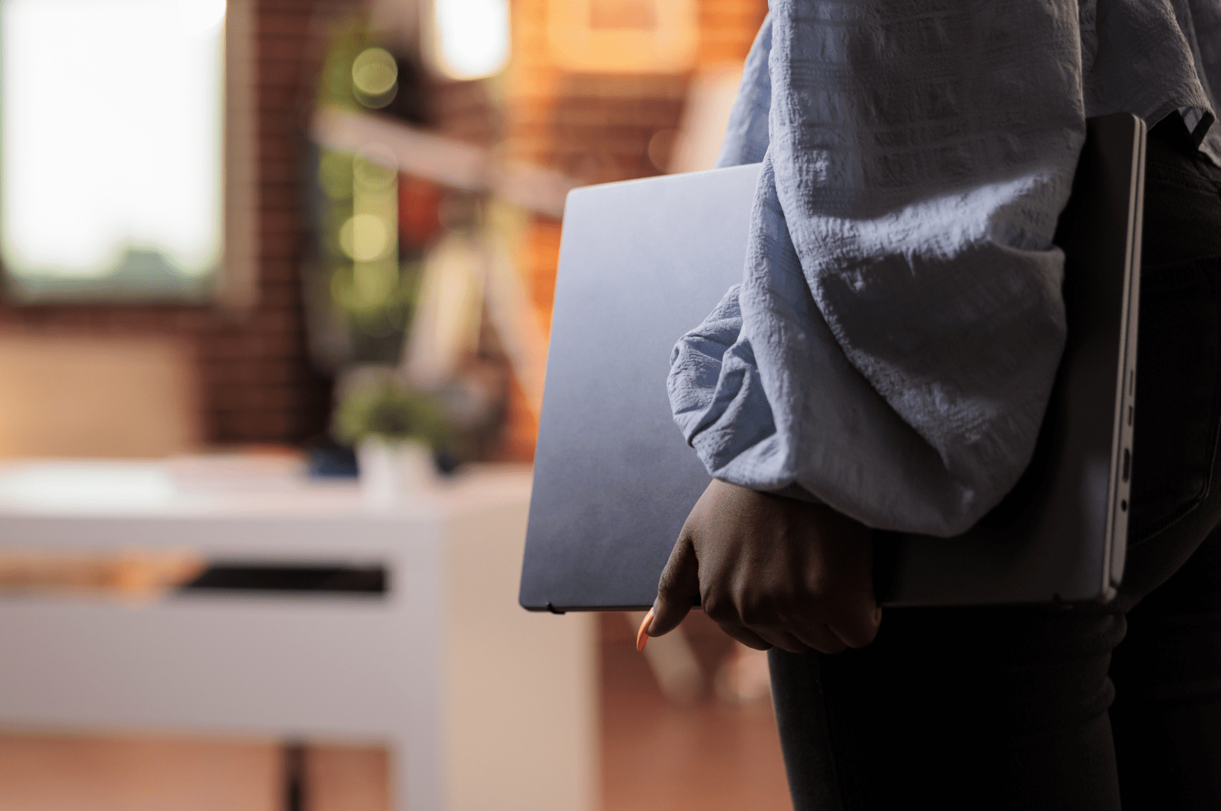 A business manager holding a laptop.