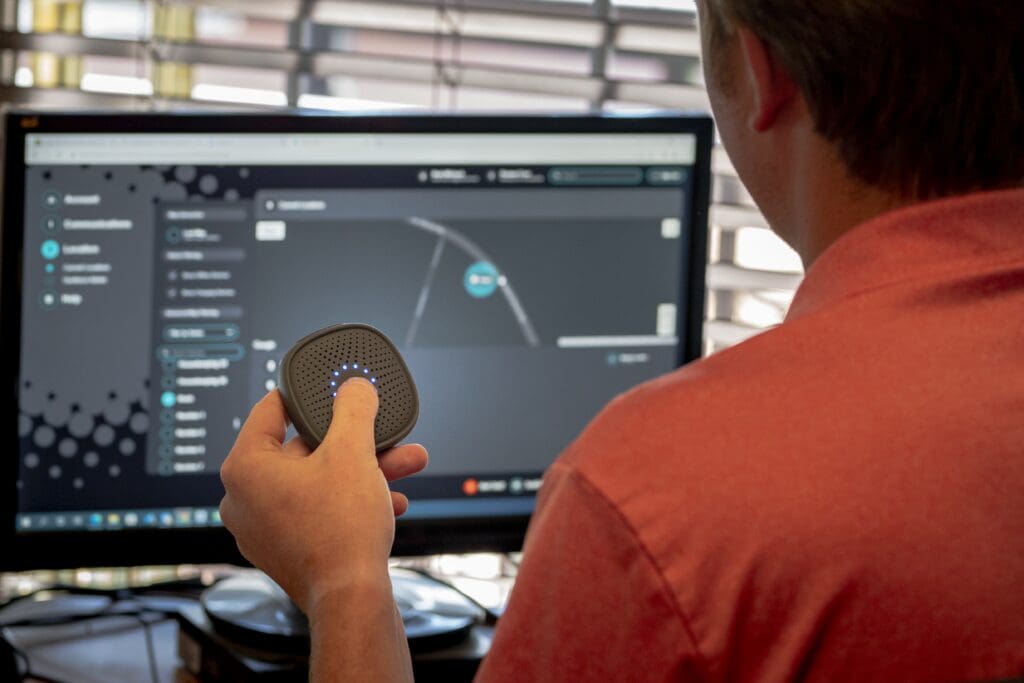 Man sitting at relay dashboard holding a Relay