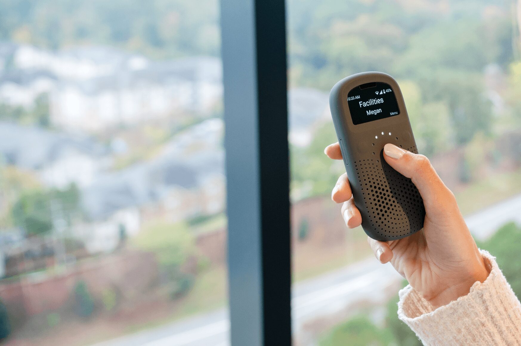 Woman's hand holding RelayX device