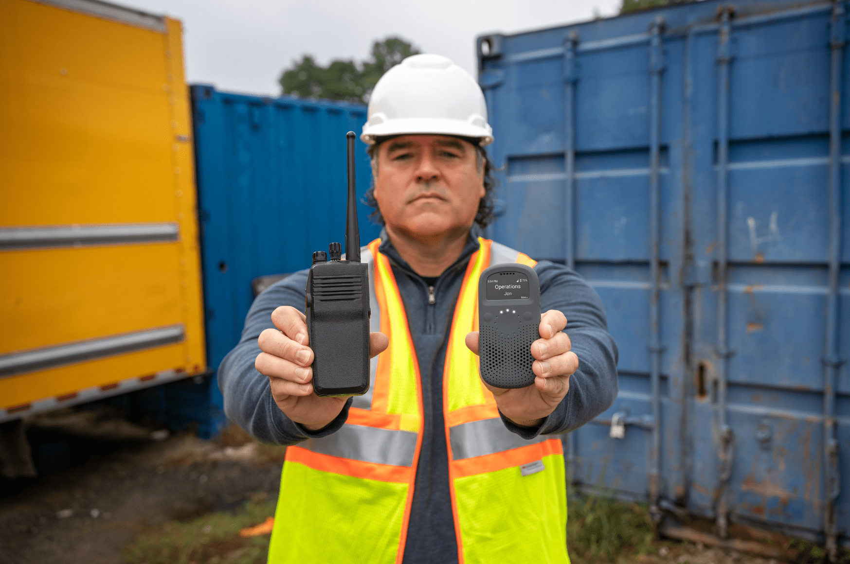 Man Holding RelayX vs Radios for Audio Comparison in Industrial Setting