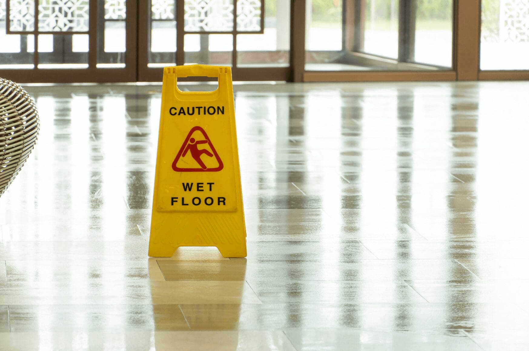 Yellow wet floor caution sign in hotel lobby