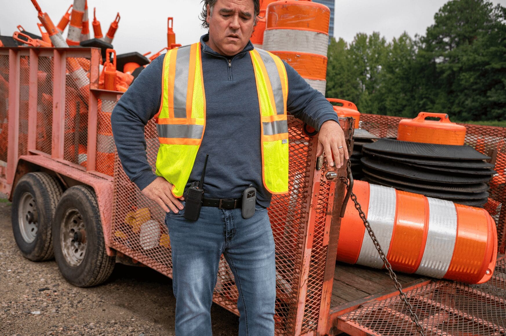 Man in construction gear wearing a walkie talkie and relayX