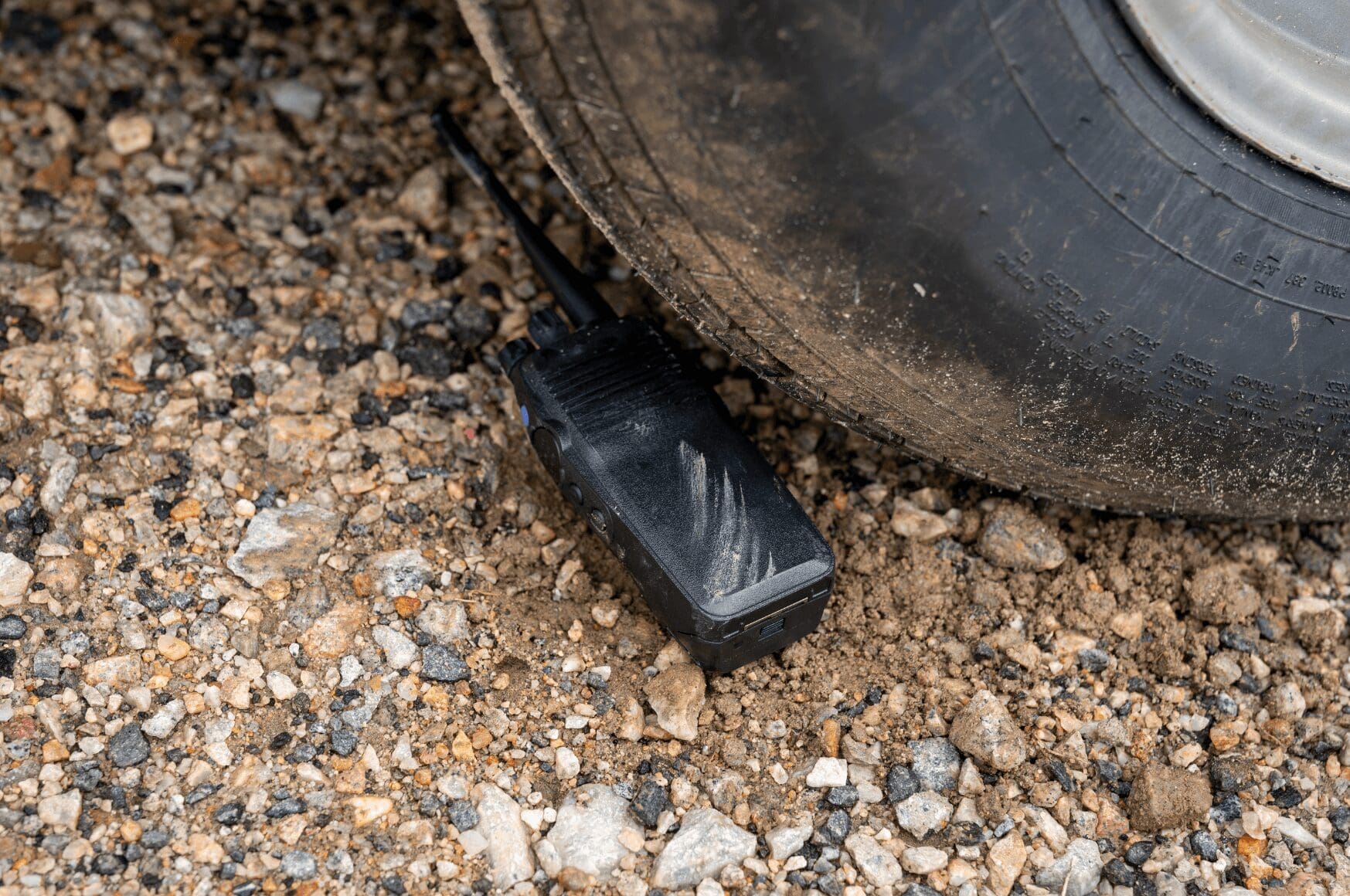 Traditional two way radio with radio interference next to truck tire