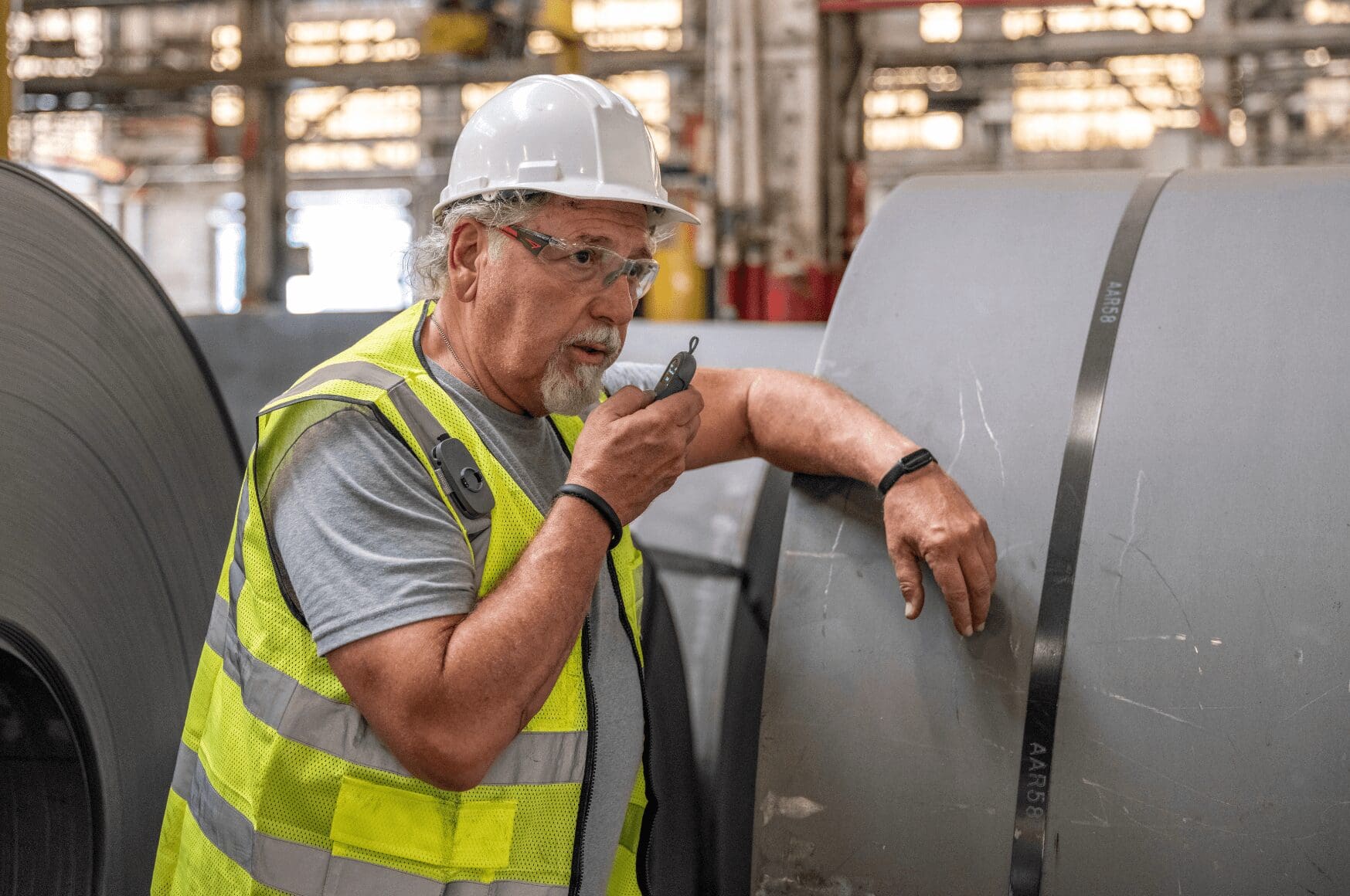 Man in industrial environment with his new communication tool: RelayX