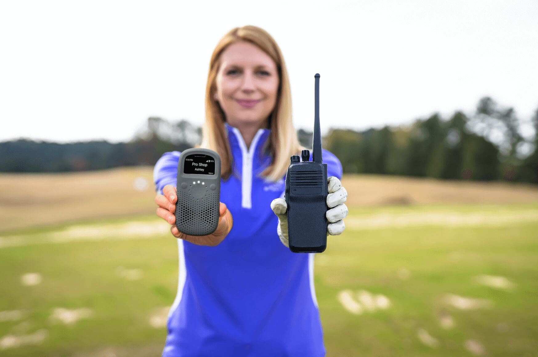 Woman on the golf course holding a two way radio and Relay