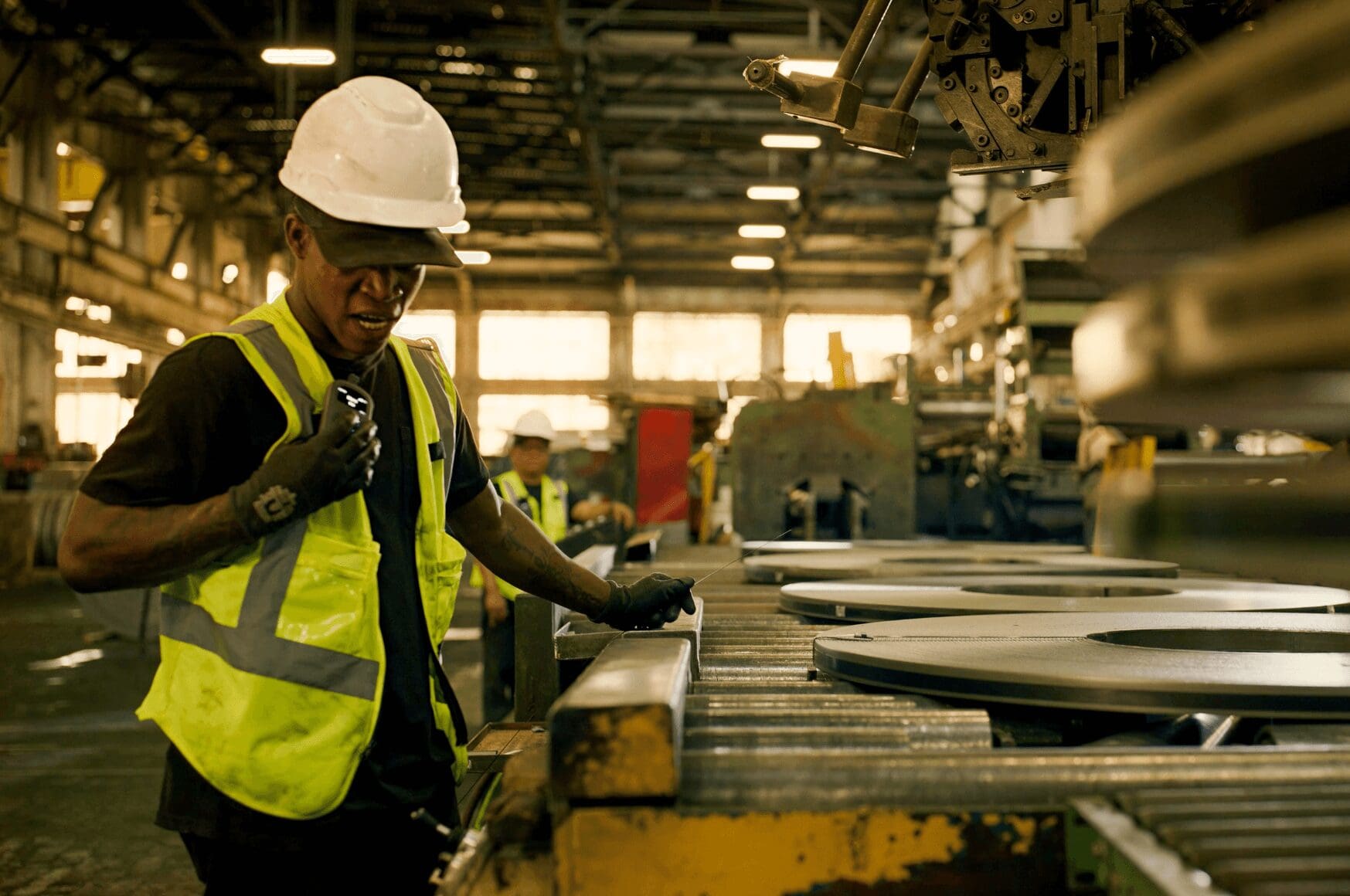 A man using Relay's push-to-talk (PTT) capabilities in an industrial environment
