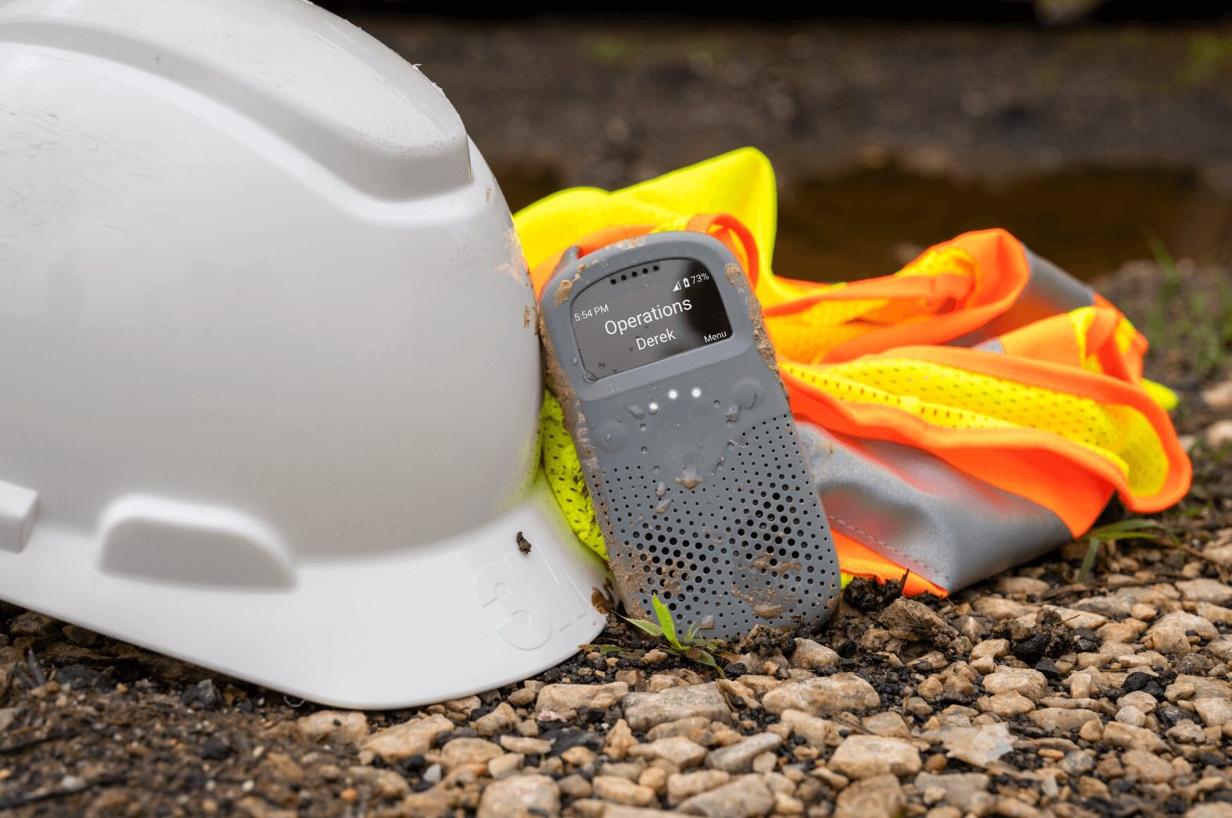 Construction Site Communication System, RelayX, next to white hard hat and orange vest