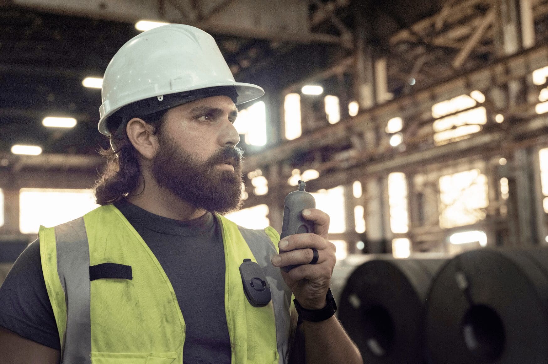 Male industrial worker using professional walkie talkie lingo on his relayx