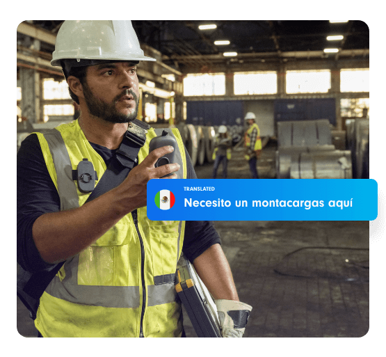 Factory worker in a hard hat and safety vest uses a Relay device to speak. A translated message overlay in Spanish reads: “Necesito un montacargas aquí,” meaning “I need a forklift here,” with a Mexican flag icon.