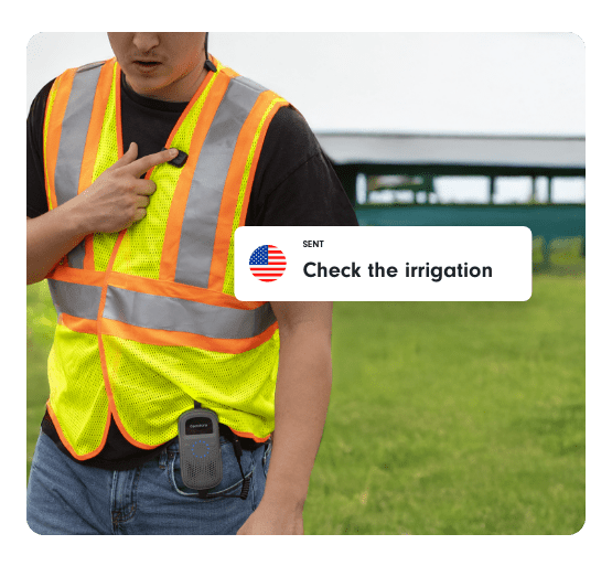 Farm worker wearing a safety vest speaks into a Relay device, sending a message that says “Check the irrigation.”