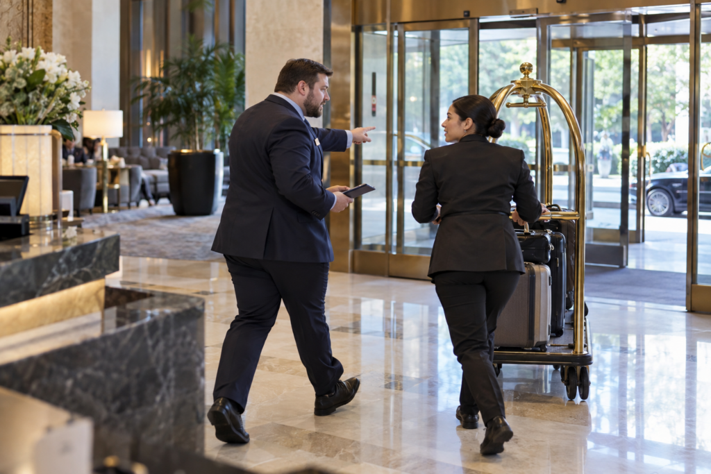 Two hotel staff communicating about a safety issue in the hotel lobby without a Relay device