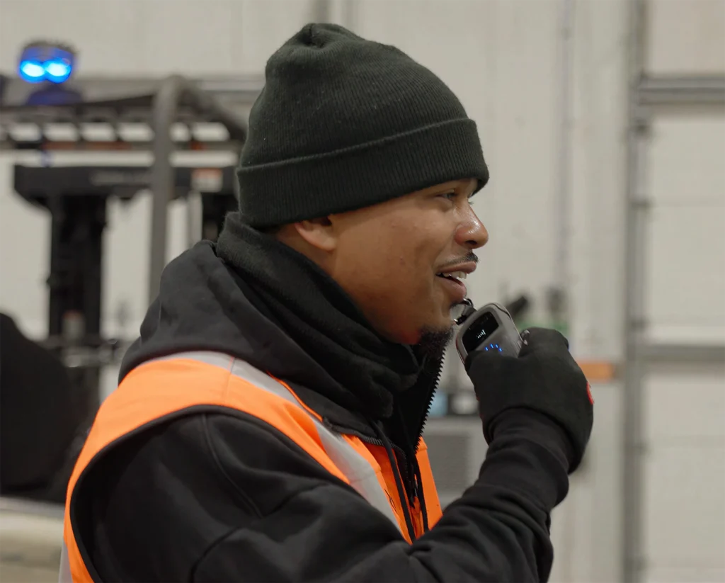 Cold storage worker communicating into his Relay on the move