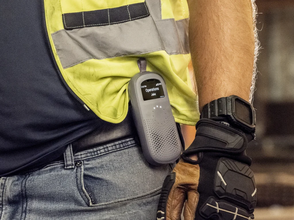 Worker in a hi-vis vest wearing a Relay device on the belt