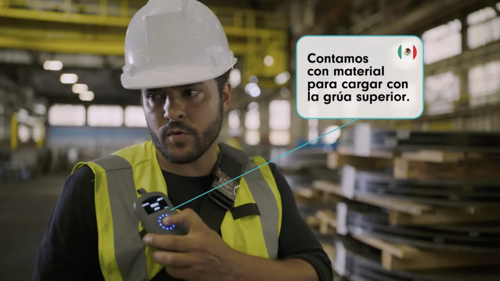 Steel worker pressing Relay to communicate in Spanish using TeamTranslate