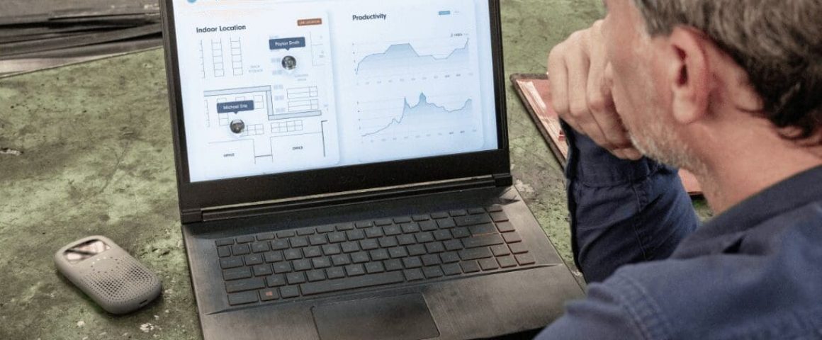 Factory manager reviews location tracking and productivity data on the Relay Dashboard displayed on a laptop, with a Relay device resting nearby.