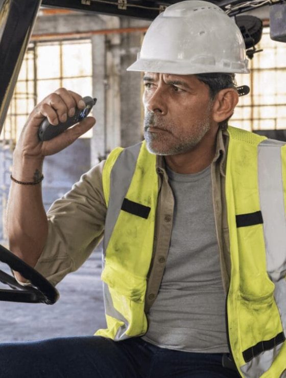 Forklift Operator Staying Connected with Relay Communication Device